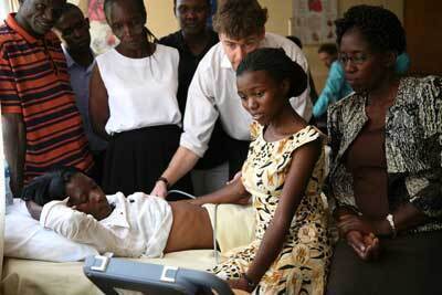 Dr. Harvey training a midwife in Kisumu, Kenya