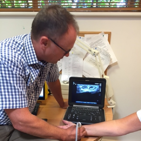 Dr. Garnett scans a patient's wrist